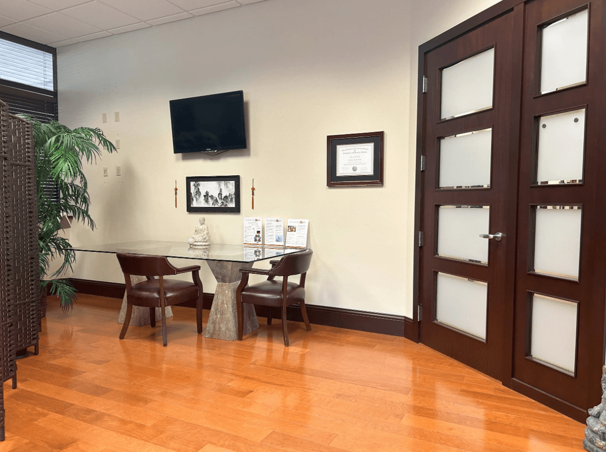 Acupuncture Xperts treatment room interior with massage table and acupuncture supplies, Boca Raton FL